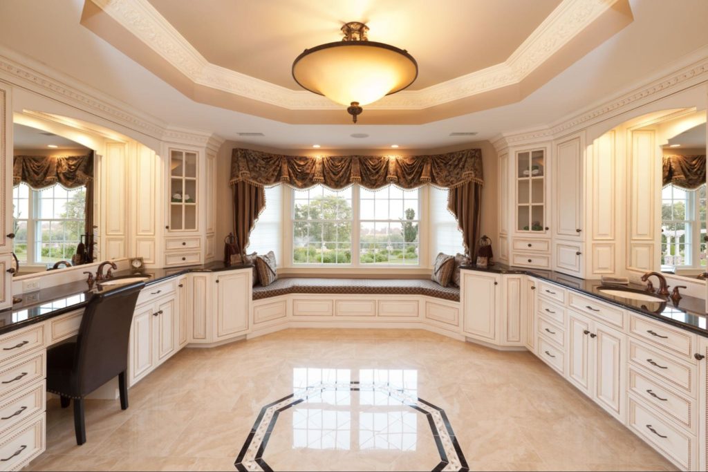 Large bathroom with custom-built white cabinetry.