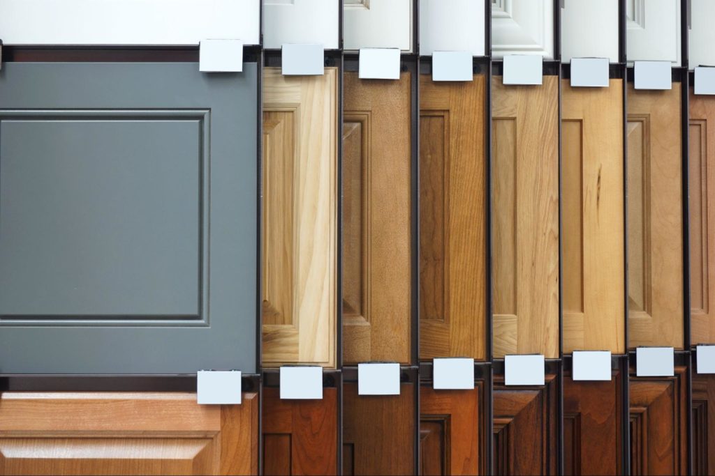 16 stock cabinet sample doors in a variety of stain colors.