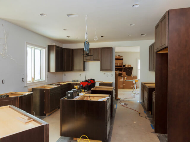 Master Design Cabinetry's craftsmanship in progress, with elegant brown cabinets installed in a kitchen remodel.
