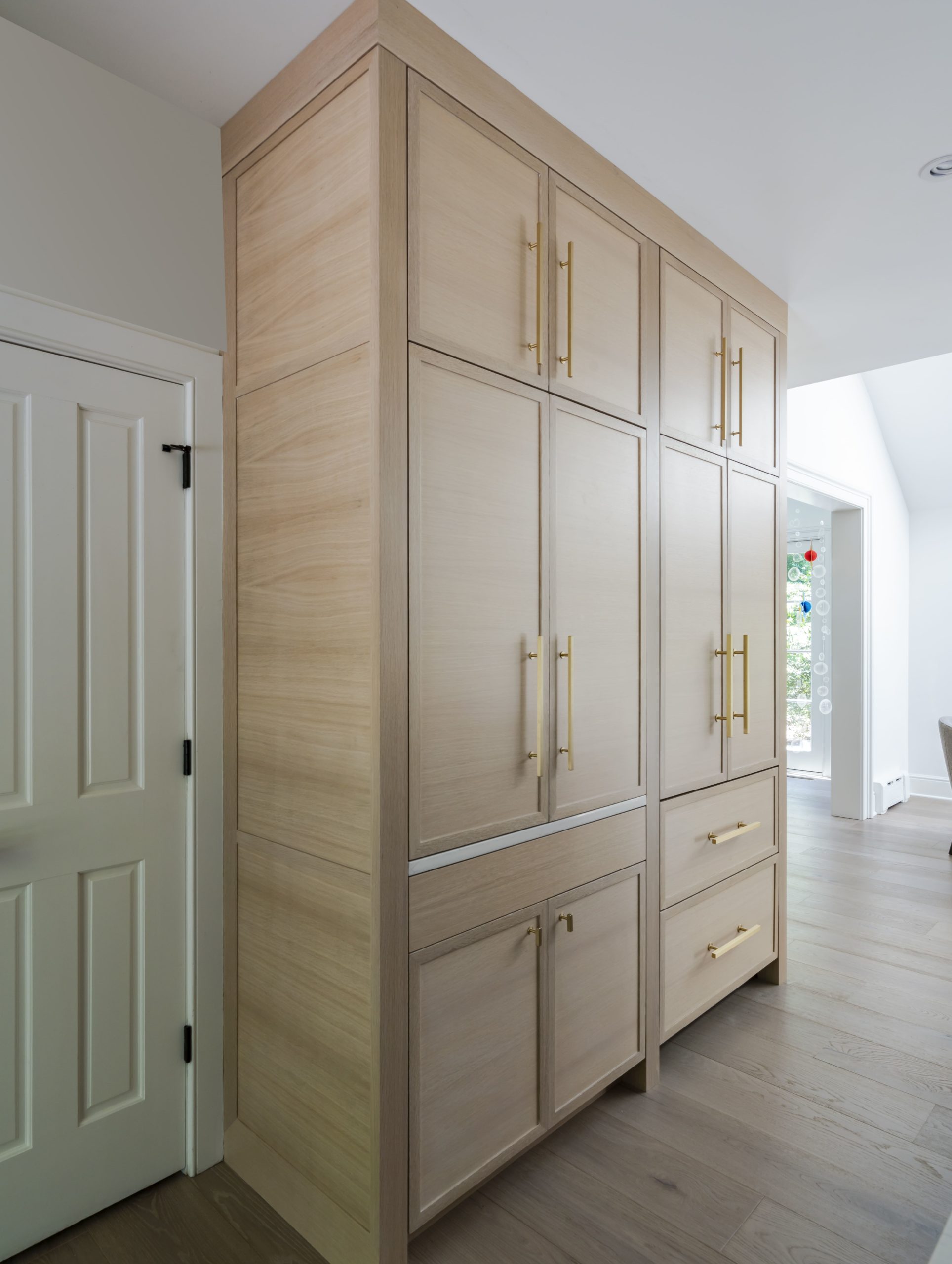 White oak cabinet refrigerator front with additional cabinet space