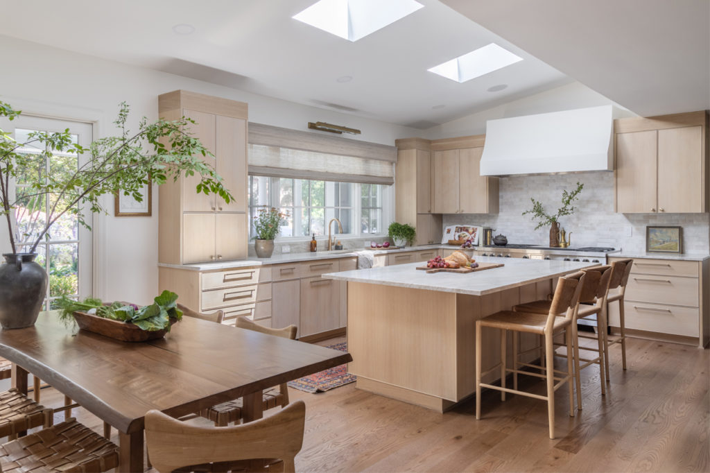 open kitchen with white oak cabinetry and white counter tops