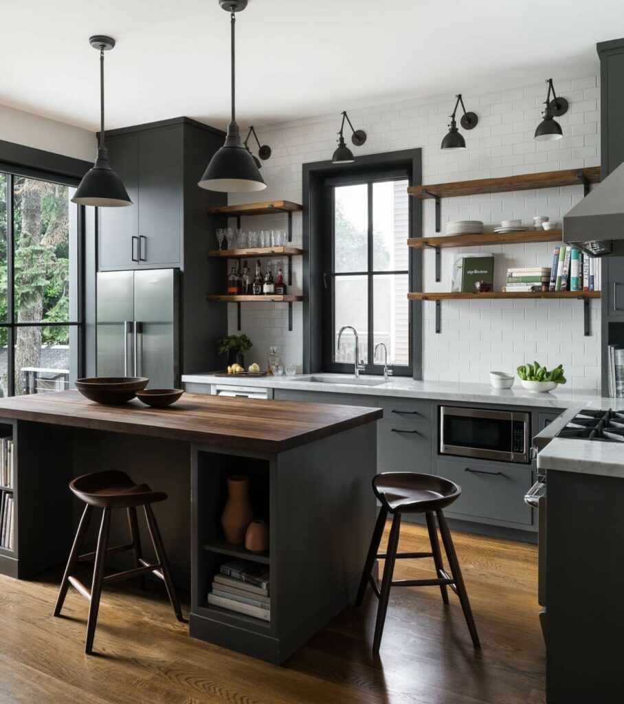A sleek kitchen showcasing dark cabinets with built-in storage options, complemented by open wooden shelving and a spacious kitchen island.